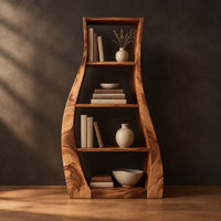 Tall bookshelf with wavy side panels and open shelves in a dark studio against a charcoal plaster wall