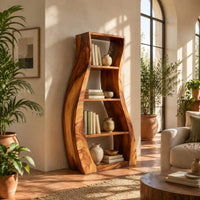 Tall bookshelf with wavy side panels and open shelves in a bright living room with arched windows and plants
