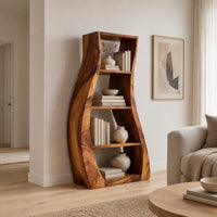 Tall bookshelf with wavy side panels and open shelves in a Scandinavian living room with white walls