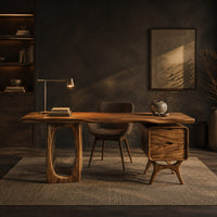 Wooden desk with an oval leg frame, a wavy top and a side pedestal in a dark home office at golden hour
