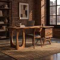 Wooden desk with an oval leg frame, a wavy top and a side pedestal in an industrial loft home office with exposed brick