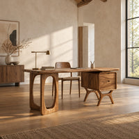 Wooden desk with an oval leg frame, a wavy top and a side pedestal in a bright open plan home office