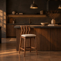 Bar stool with a wavy slatted back and a padded seat in a dark kitchen at golden hour
