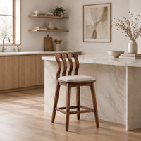 Bar stool with a wavy slatted back and a padded seat in a Scandinavian kitchen with white walls