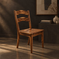Wooden chair with two wavy back slats and tapered legs, three-quarter view showing the grain