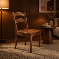 Wooden chair with two wavy back slats and tapered legs in an evening living room with walnut wall paneling