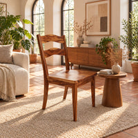 Wooden chair with two wavy back slats and tapered legs in a bright living room with arched windows and plants