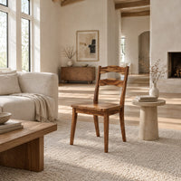 Wooden chair with two wavy back slats and tapered legs in a bright open plan living room