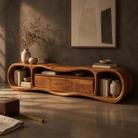 Corner detail of wavy tv stand with open oval end bays and a three panel center beside wood, brass and linen samples