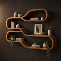 Wall shelf of two stacked flowing loops joined by a wavy ledge in a dark studio against a charcoal plaster wall