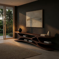 Low TV console with carved web supports between shelves in a living room at golden hour