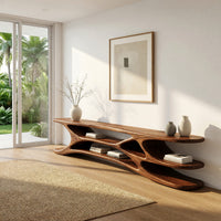 Low TV console with carved web supports between shelves in a bright modern living room