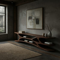 Low TV console with carved web supports between shelves in a concrete and timber loft