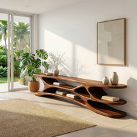 Low TV console with carved web supports between shelves in an open plan space in daylight