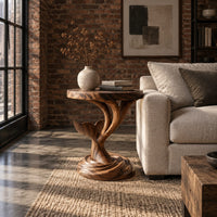 Side table with a carved whale tail on a spiral stem and coiled base in an industrial loft living room with exposed brick