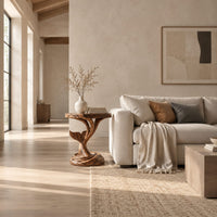 Side table with a carved whale tail on a spiral stem and coiled base in a bright open plan living room