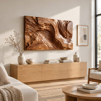 Wide wood wall art carved with flowing ridges like a contour map above a light oak sideboard in daylight
