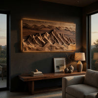 Wide landscape wall relief with layered sky bands above a low console in an evening living room