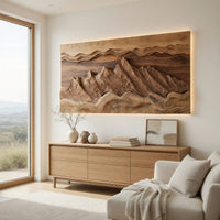 Wide landscape wall relief with layered sky bands above a light oak sideboard in daylight