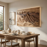 Wide landscape wall relief with layered sky bands beside a dining table in natural light