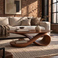 Oval top coffee table on a swooping ribbon pedestal with an oval base disc in an industrial loft living room with exposed brick