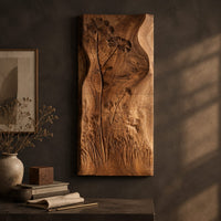 Detail of tall wooden wall art panel with carved wildflowers and a wavy edge beside wood, brass and linen samples
