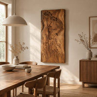 Tall wooden wall art panel with carved wildflowers and a wavy edge beside a dining table in natural light