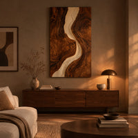 Tall wood wall art panel with a winding cream channel through dark swirling grain above a low console in an evening living room