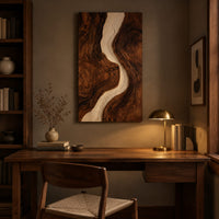 Tall wood wall art panel with a winding cream channel through dark swirling grain above a desk in a dark study corner