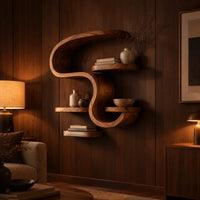 Sculpted wall shelf in an s shape with a hooked top and small ledges in an evening living room with walnut wall paneling