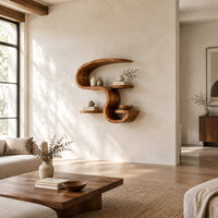 Sculpted wall shelf in an s shape with a hooked top and small ledges in a bright open plan living room
