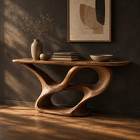 Console table with a winding ribbon base and a long tapered top, three-quarter view showing the grain