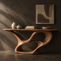 Corner detail of console table with a winding ribbon base and a long tapered top beside wood, brass and linen samples