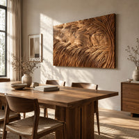 Large rectangle wooden wall panel carved with deep flowing windswept strands beside a dining table in natural light