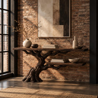 Console table with a leaning tree root base and one lower shelf in an industrial loft entryway with exposed brick