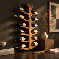 Corner detail of wine rack with a central trunk and six pairs of branching wooden arms beside wood, brass and linen samples