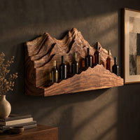 Wine rack with layered carved mountain peaks and a ridge shaped ledge, three-quarter view showing the grain