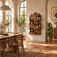 Wine rack with a mountain ridge slab back and four staggered ledges in a bright dining room with arched windows and plants