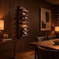 Tall wine rack with stacked angled cradle arms on a slab backboard in an evening dining room with walnut wall paneling