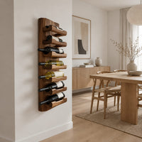 Tall wine rack with stacked angled cradle arms on a slab backboard in a Scandinavian dining room with white walls