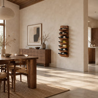 Tall wine rack with stacked angled cradle arms on a slab backboard in a bright open plan dining room