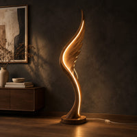 Wing shaped wooden floor lamp with a glowing edge line, three-quarter view showing the grain