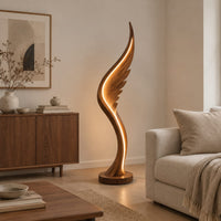 Wing shaped wooden floor lamp with a glowing edge line in a Scandinavian living room with white walls
