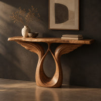 Console table with feather carved wings rising from an open teardrop base, three-quarter view showing the grain