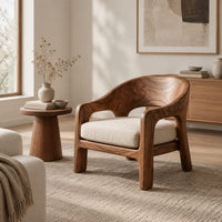 Wraparound lounge chair with arched cutout arms and an upholstered seat in a Scandinavian living room with white walls
