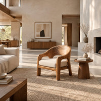 Wraparound lounge chair with arched cutout arms and an upholstered seat in a bright open plan living room