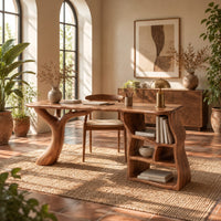 Desk with a branch shaped leg and a wavy open shelf unit in a bright home office with arched windows and plants