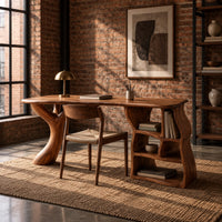 Desk with a branch shaped leg and a wavy open shelf unit in an industrial loft home office with exposed brick