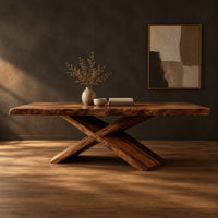 Dining table with crossed legs and a thick rectangular top in a dark studio against a charcoal plaster wall