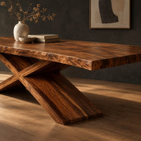 Corner detail of dining table with crossed legs and a thick rectangular top beside wood, brass and linen samples